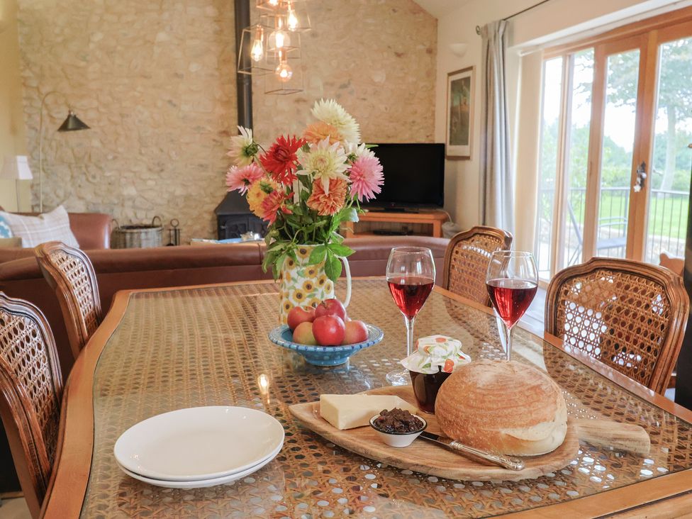 A dining room with a table set for a meal at The Sundowner in Wyke Nr. Axminster