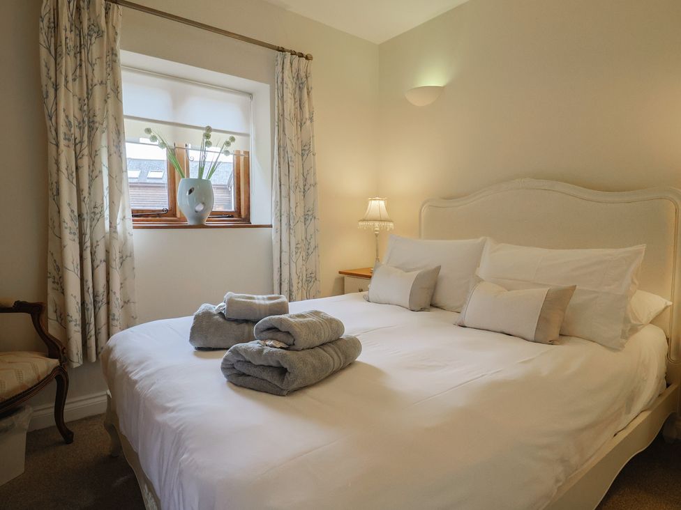 A bedroom with a bed and a window at The Sundowner in Wyke Nr. Axminster