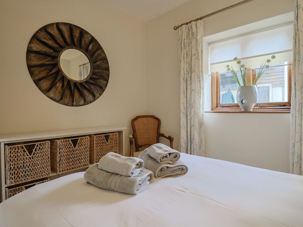 A bedroom with towels on a bed at The Sundowner in Wyke Nr. Axminster