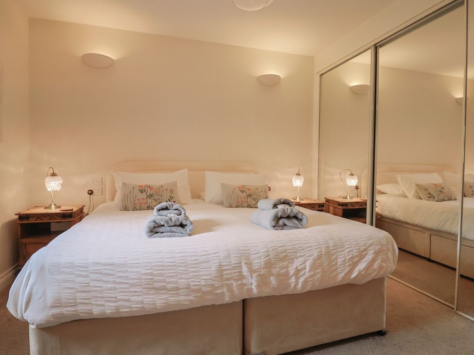 A bedroom with a bed and bedside tables at The Sundowner in Wyke Nr. Axminster