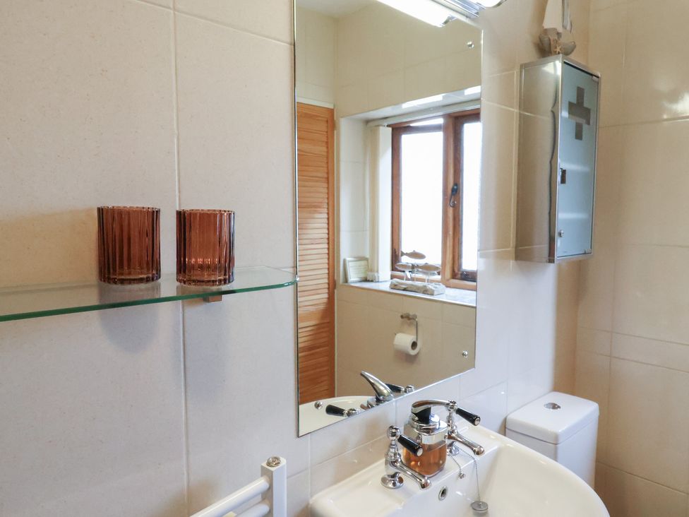 A bathroom with a mirror and sink at The Sundowner in Wyke Nr. Axminster