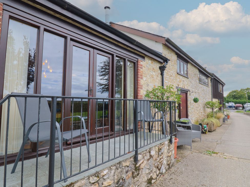 A balcony with chairs and plants at The Sundowner in Wyke Nr. Axminster