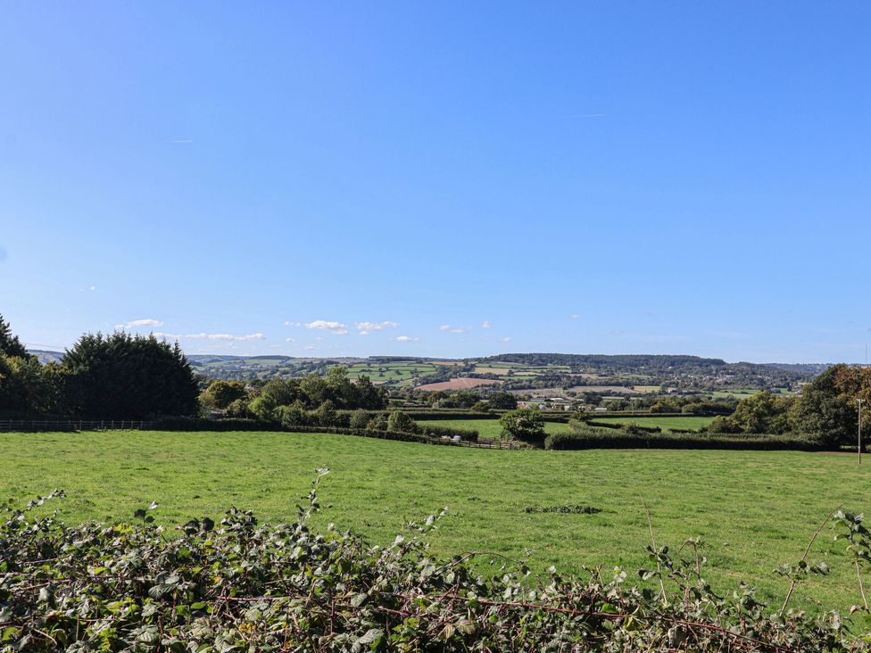 A view of a green field and trees at The Sundowner in Wyke Nr. Axminster