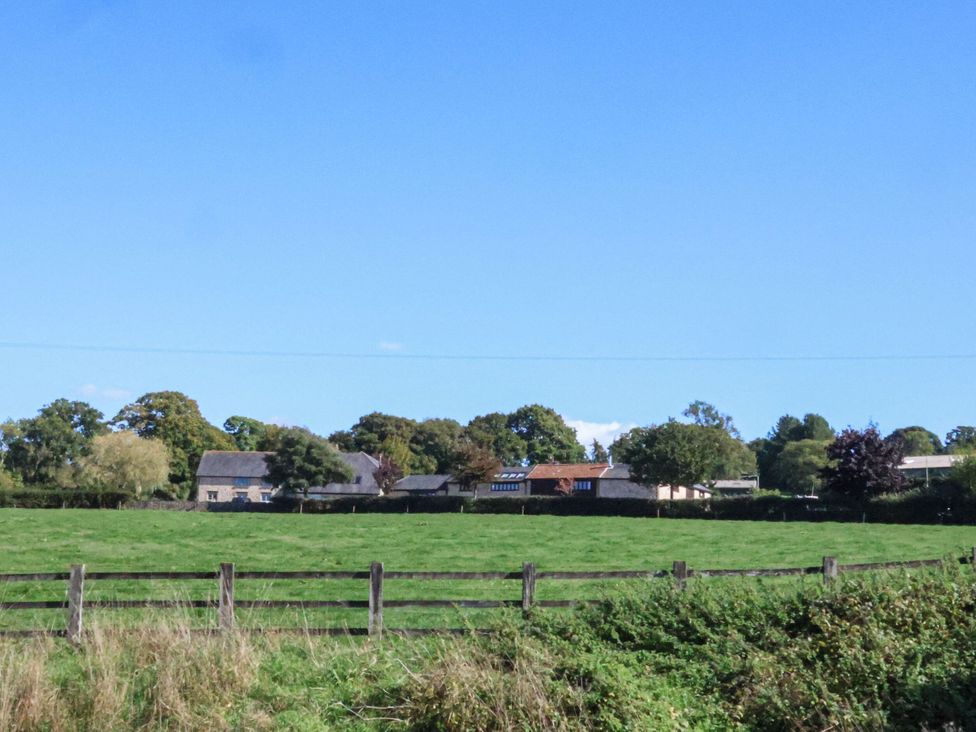 A view of multiple houses and trees in a field at The Sundowner in Wyke Nr. Axminster