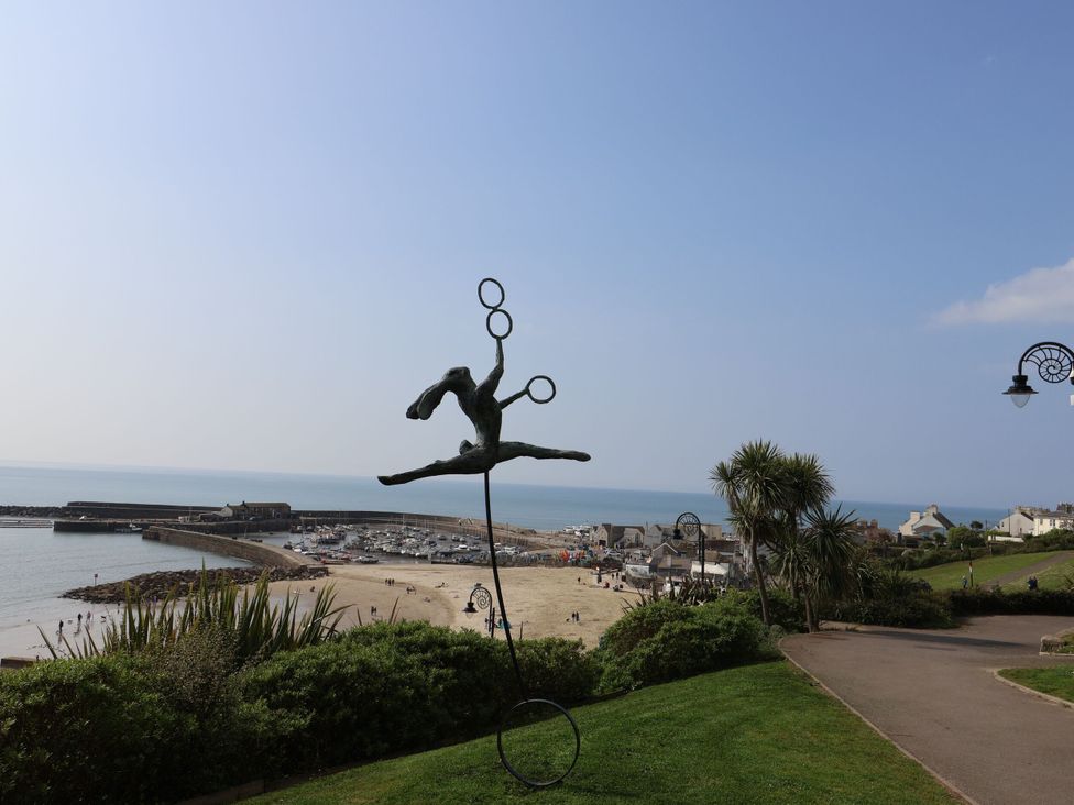 A scenic view of a beach with a sculpture and boats at The Sundowner in Wyke Nr. Axminster