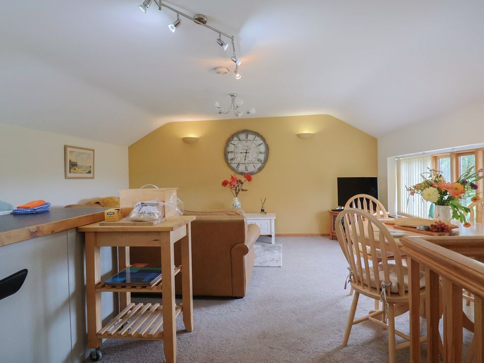 A living room with a sofa and dining area at The Granary Wyke Nr Axminster