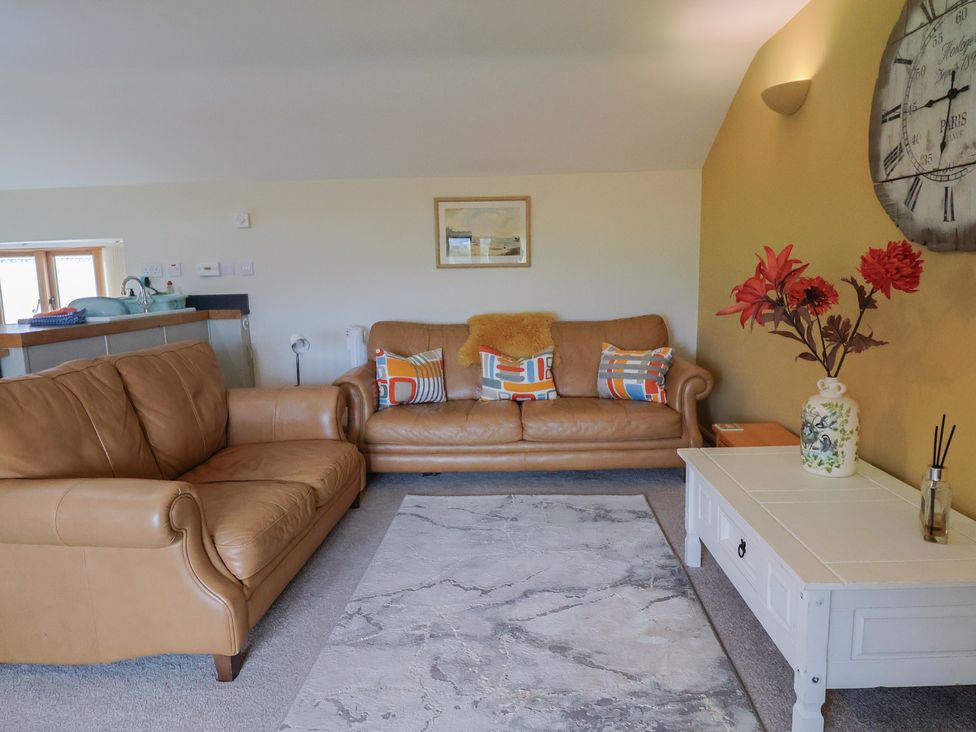 A living room with a sofa and coffee table at The Granary in Wyke Nr Axminster