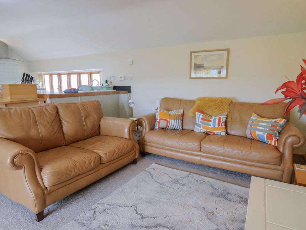 A living room with two leather sofas and a coffee table at The Granary Wyke Nr Axminster