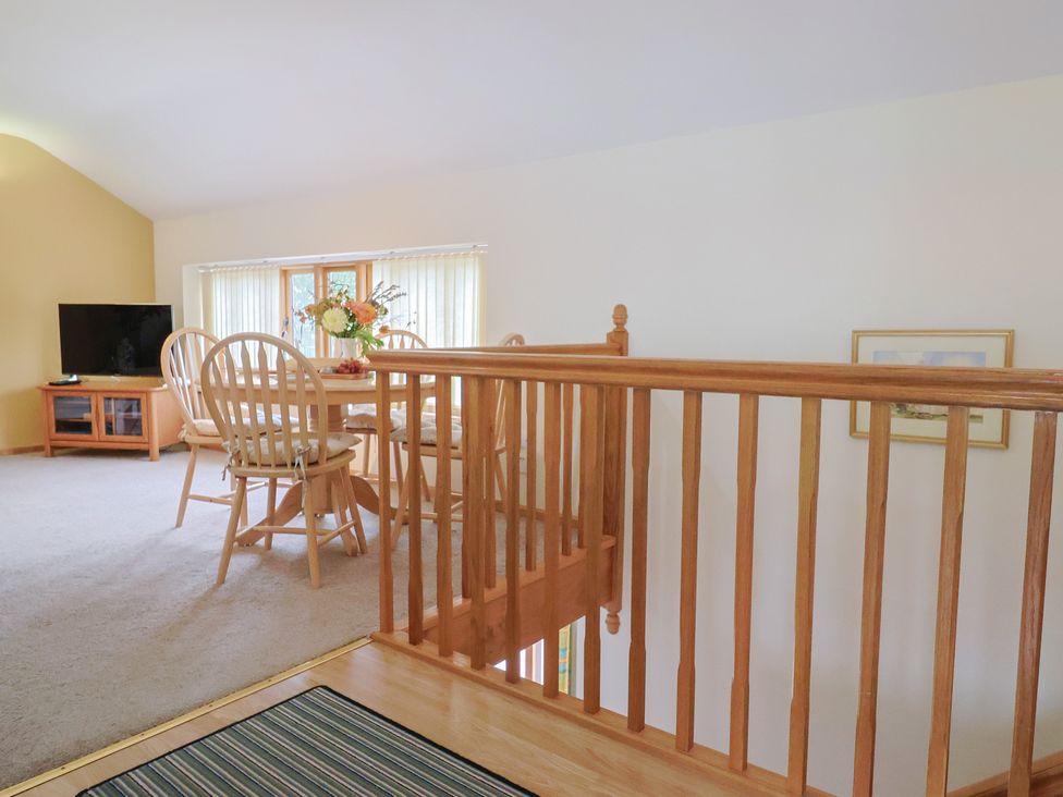 A dining room with a table and chairs at The Granary in Wyke Nr Axminster