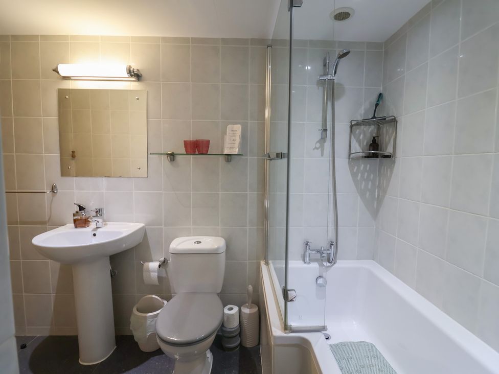 A bathroom with a sink, toilet, shower, and bathtub at The Granary in Wyke Nr Axminster