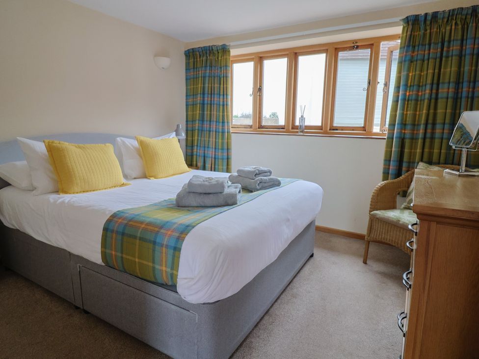 A bedroom with a bed and towels on The Granary in Wyke Nr Axminster