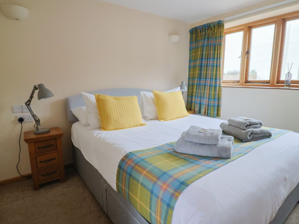 A bedroom with a double bed and a nightstand at The Granary in Wyke Nr Axminster
