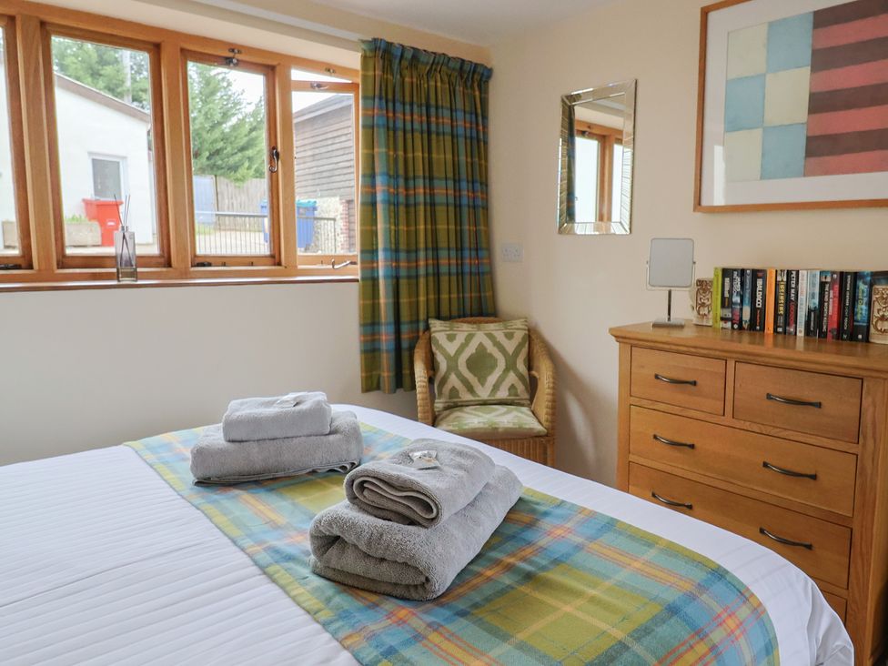 A bedroom with a bed and dresser at The Granary, Wyke Nr Axminster