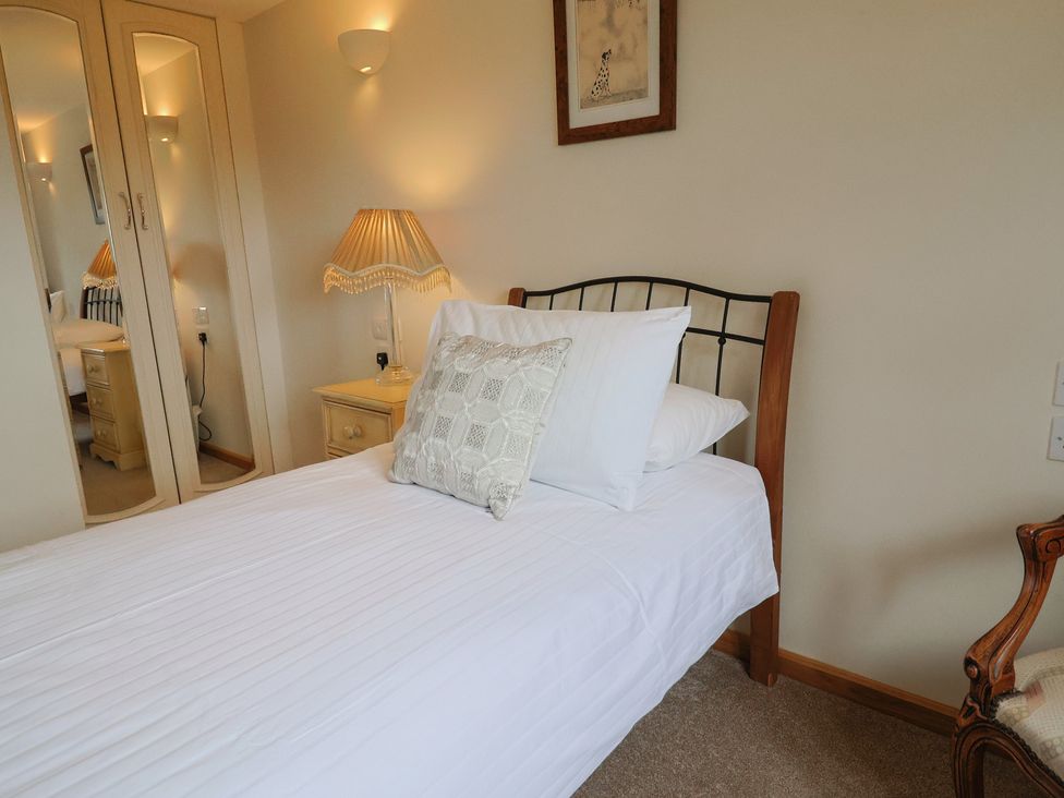 A bedroom with a bed and a nightstand at The Granary in Wyke Nr Axminster