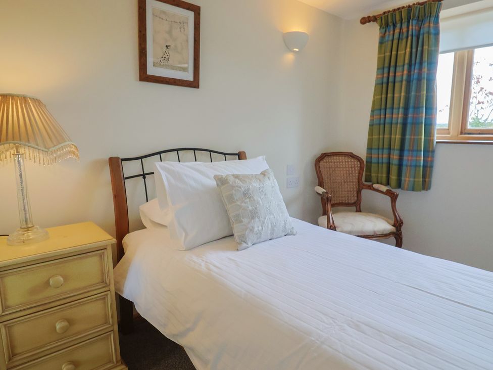 A bedroom with a bed and a bedside table at The Granary Wyke Nr Axminster