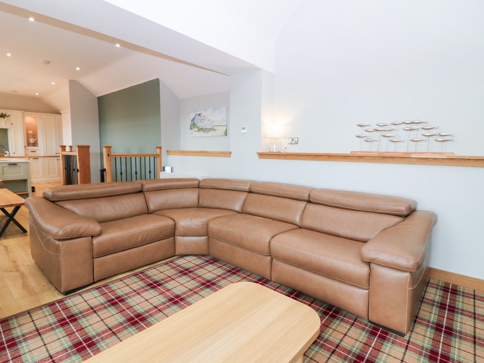 A living room with a sofa and coffee table at The Old Kipper Hoose in Banff