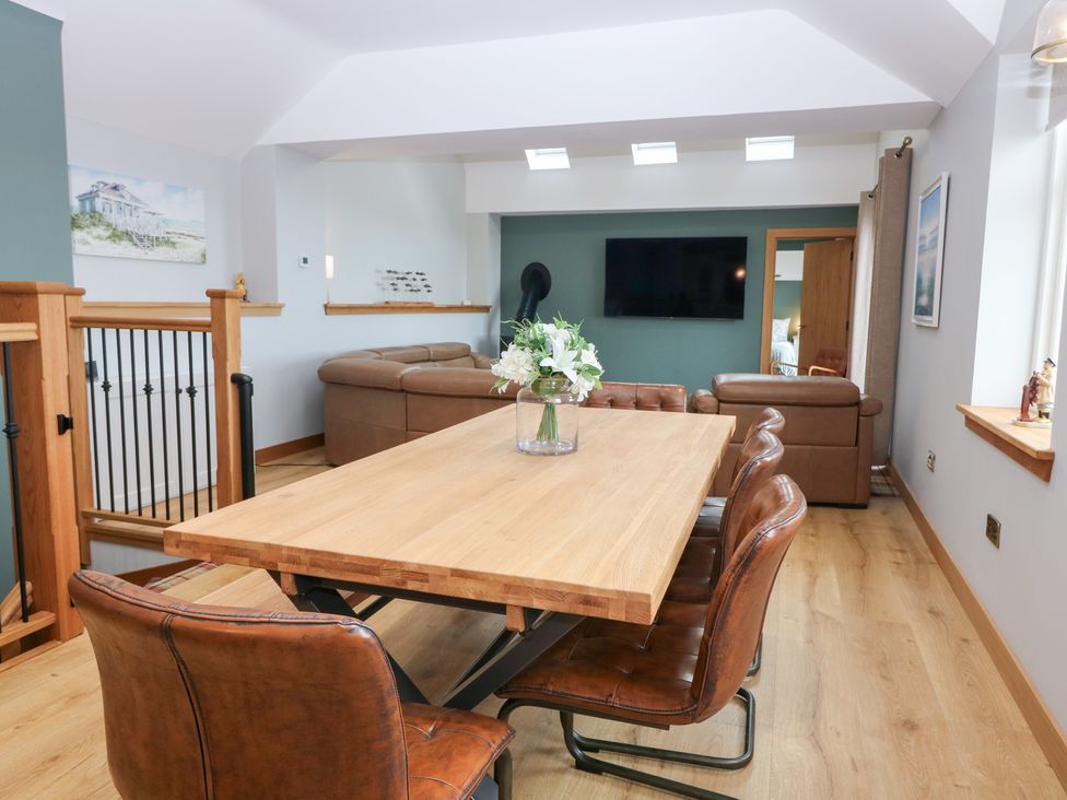 A dining room with a table and chairs at The Old Kipper Hoose in Banff