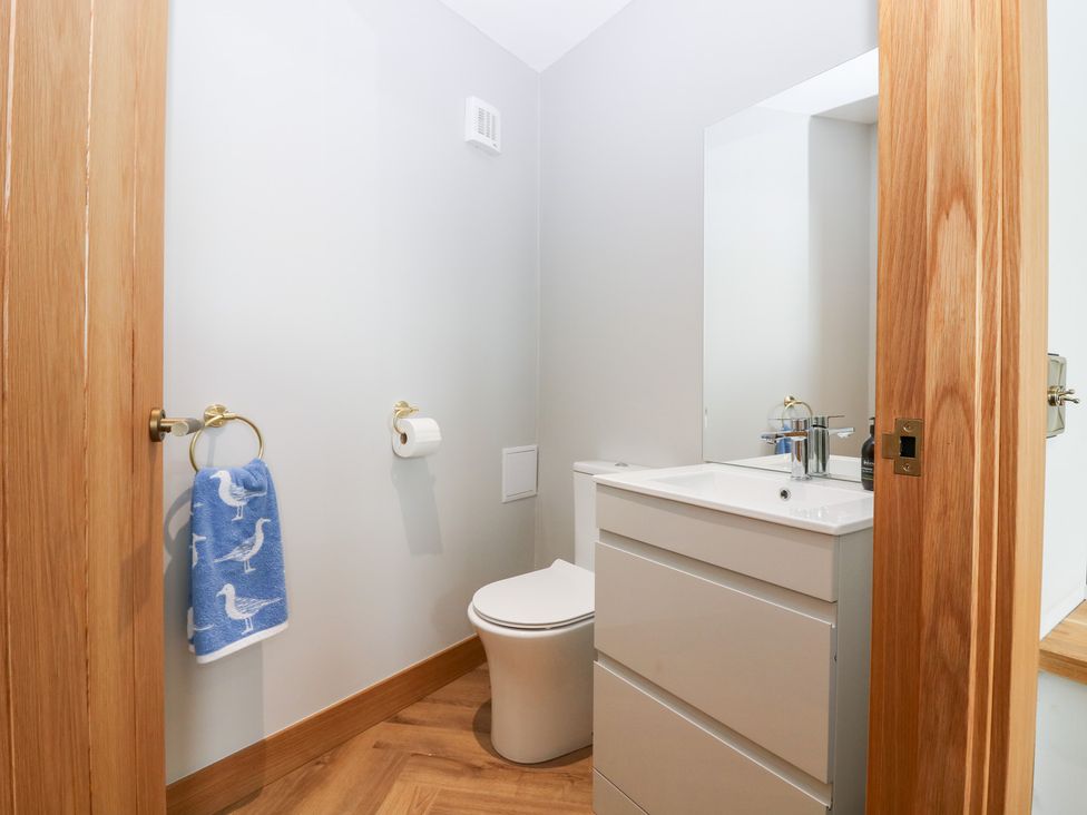 A bathroom with a sink and toilet at The Old Kipper Hoose in Banff