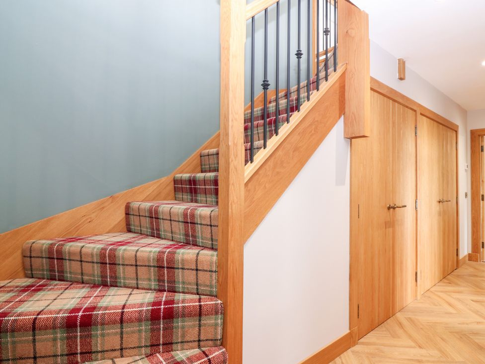 A staircase and doors in a hallway at The Old Kipper Hoose in Banff