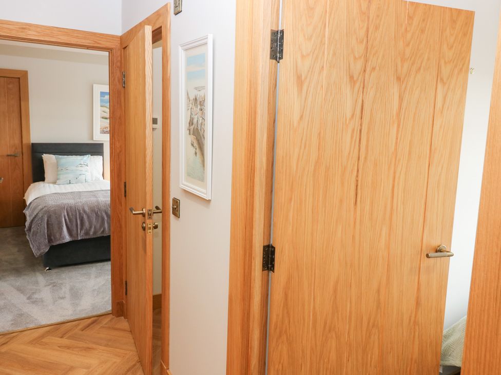 A bedroom with a bed and artwork at The Old Kipper Hoose in Banff