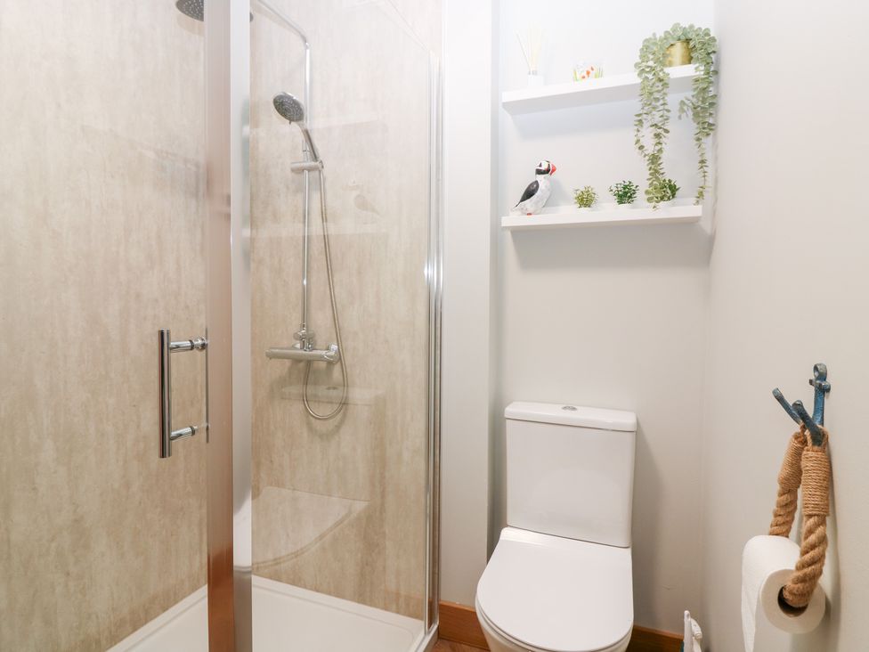 A bathroom with a shower and toilet at The Old Kipper Hoose in Banff