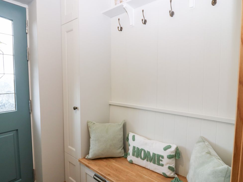 An entrance hall with a door and storage at The Old Kipper Hoose in Banff