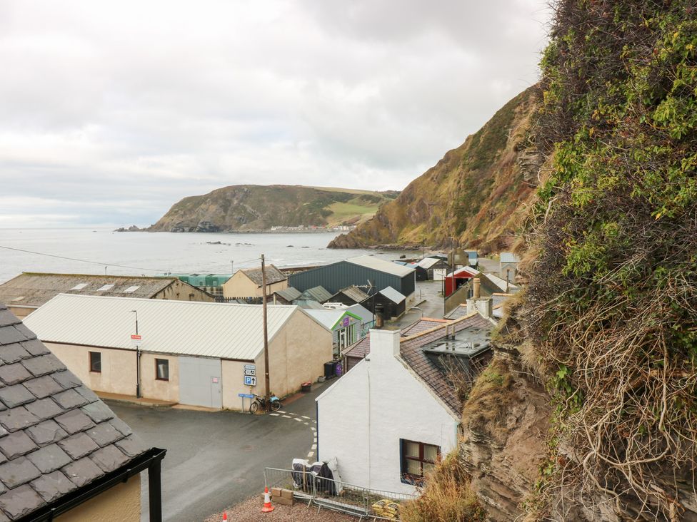 A coastal village with buildings overlooking the sea at The Old Kipper Hoose in Banff