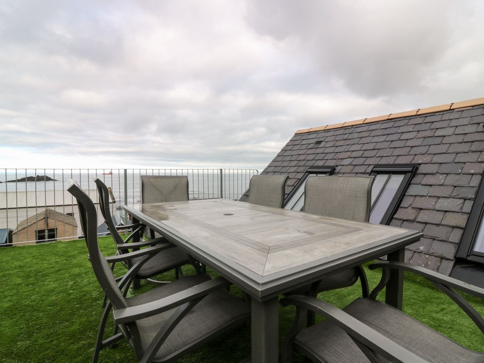An outdoor terrace with a table and chairs at The Old Kipper Hoose in Banff