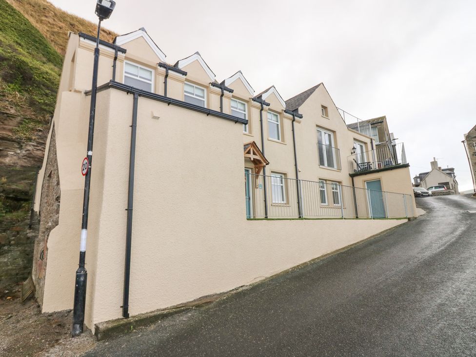 A building with balcony on a sloped street at The Old Kipper Hoose in Banff