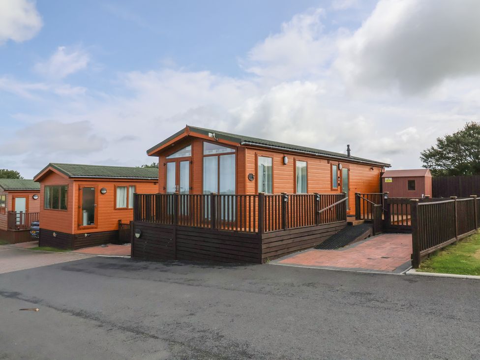 A mobile home with decking at Cody Cottage Lodge Mullacott Park near Ilfracombe