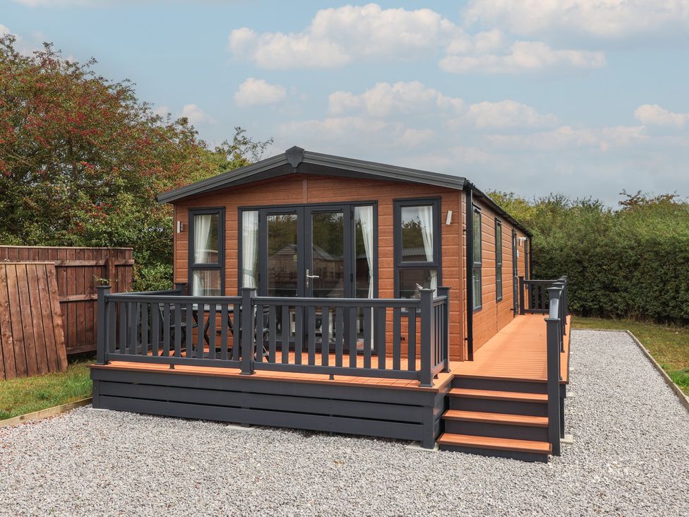 A cabin with a deck and steps at Meadows Park 1 Great Hatfield near Hornsea