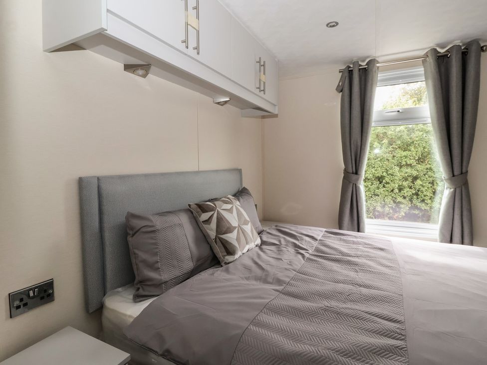 A bedroom with a bed and a wall cabinet at Meadows Park 1 Great Hatfield near Hornsea