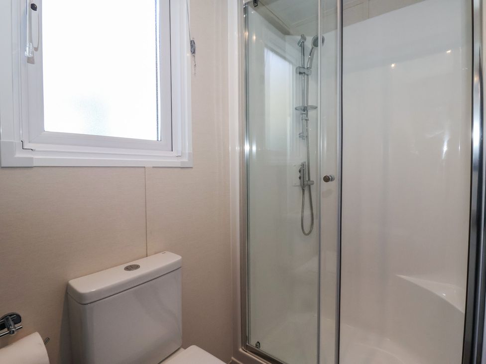 A bathroom with a shower and toilet at Meadows Park 1 Great Hatfield near Hornsea