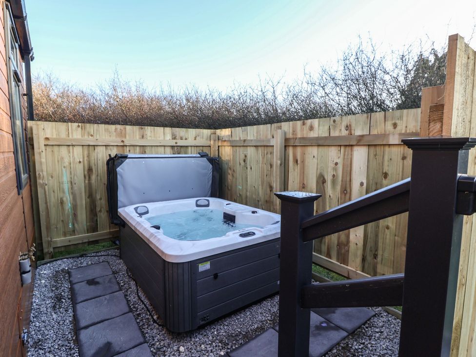A hot tub in an enclosed outdoor space at Meadows Park 1 Great Hatfield near Hornsea