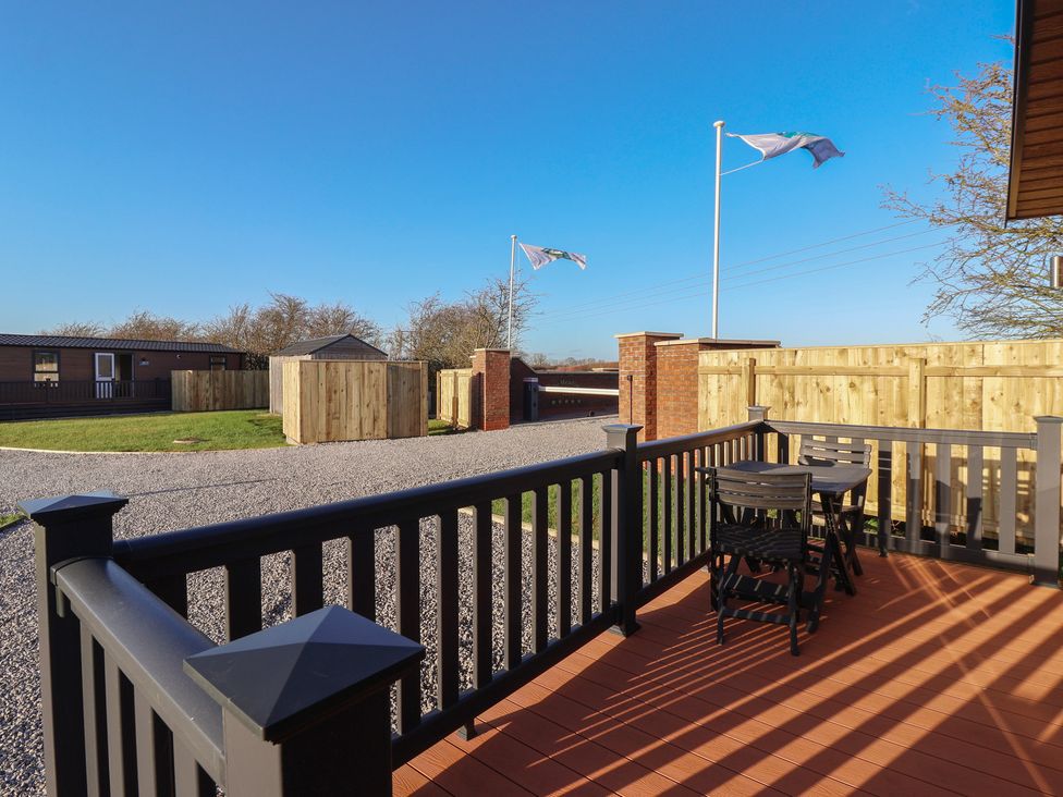 An outdoor deck with table and chairs at Meadows Park 1 Great Hatfield near Hornsea