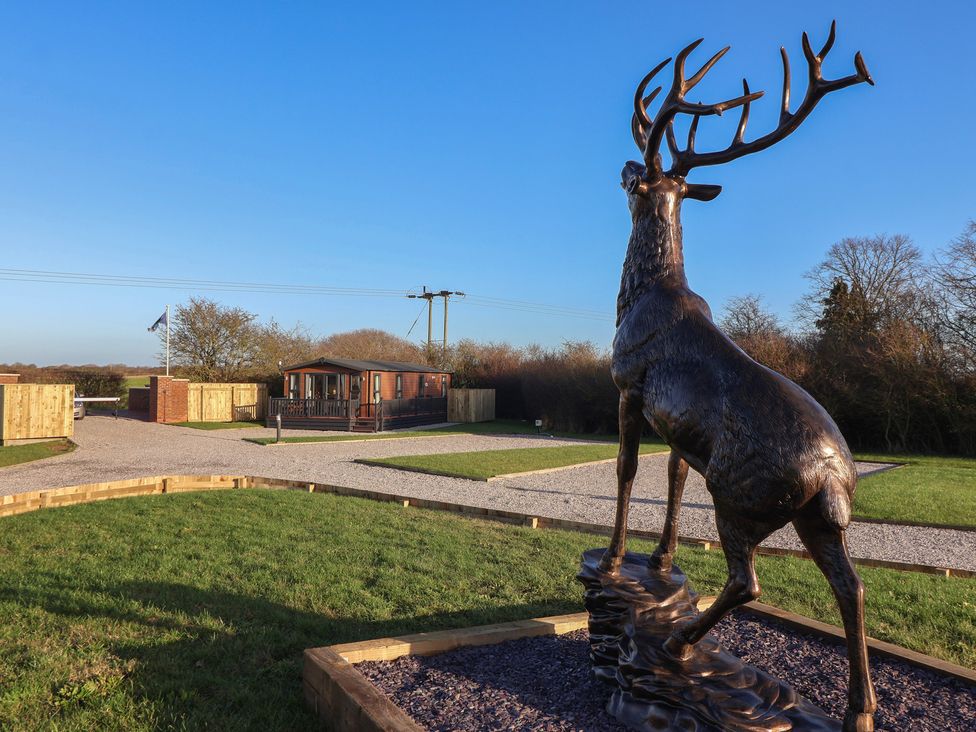 A deer statue in front of a lodge at Meadows Park 1 Great Hatfield near Hornsea