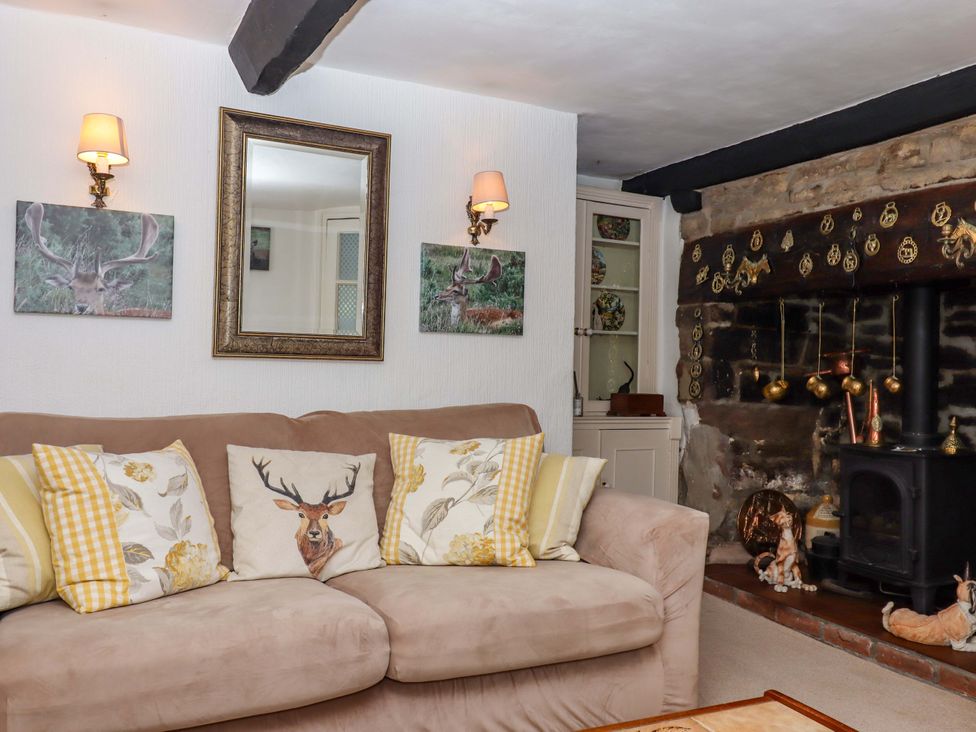 A living room with a sofa and a fireplace at Cosy Nook in South Molton