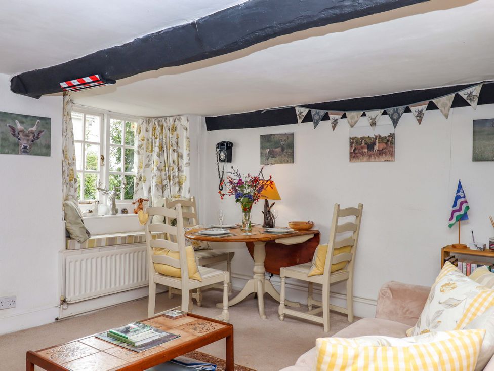 A dining room with a table and chairs at Cosy Nook South Molton