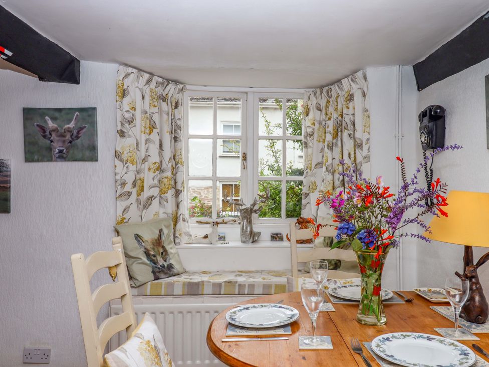 A dining room with a table set for dinner at Cosy Nook in South Molton