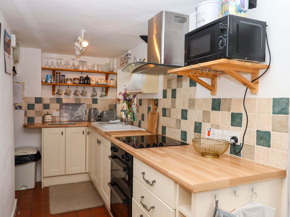 A kitchen with cabinets and appliances at Cosy Nook in South Molton
