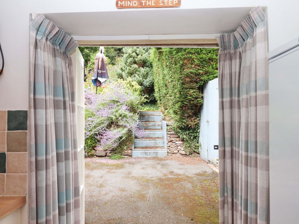 A doorway leading to steps and garden plants at Cosy Nook in South Molton