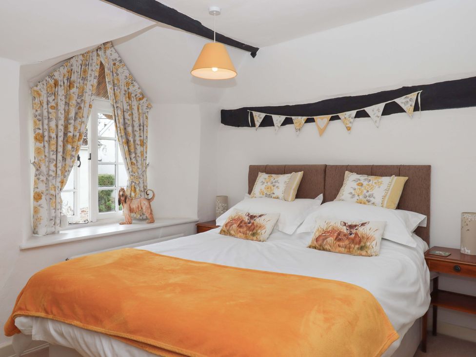 A bedroom with a bed and window at Cosy Nook in South Molton
