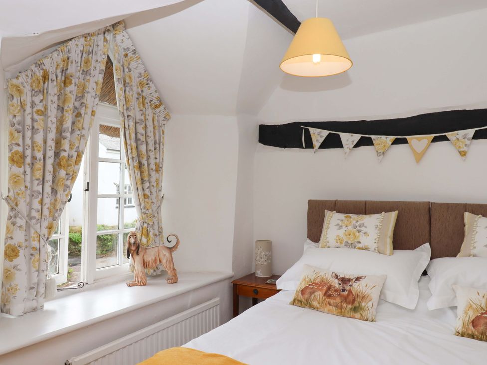 A bedroom with a bed and decorative items at Cosy Nook in South Molton