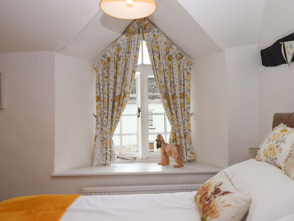 A bedroom with a window and figurine at Cosy Nook in South Molton