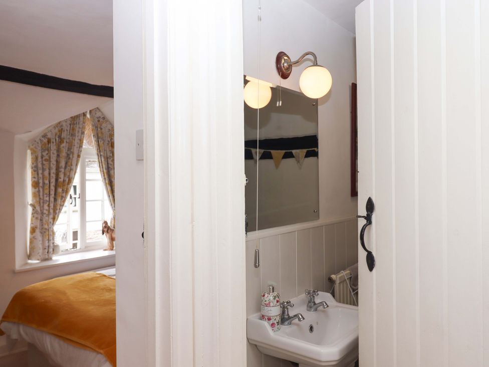 A bathroom with a sink and mirror at Cosy Nook in South Molton
