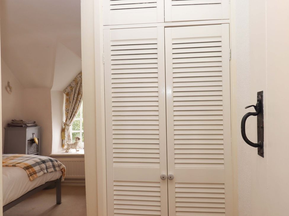 A bedroom with a bed and closet at Cosy Nook in South Molton