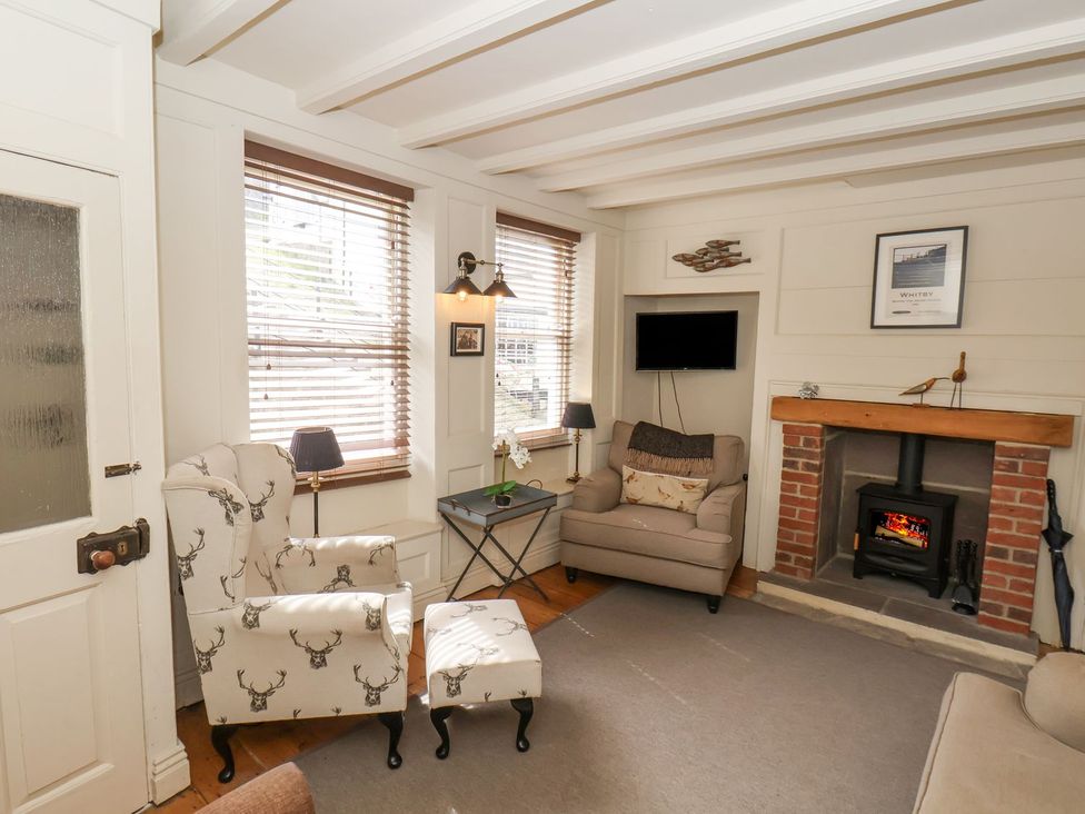 A living room with a sofa and chairs at Greenfingers in Whitby