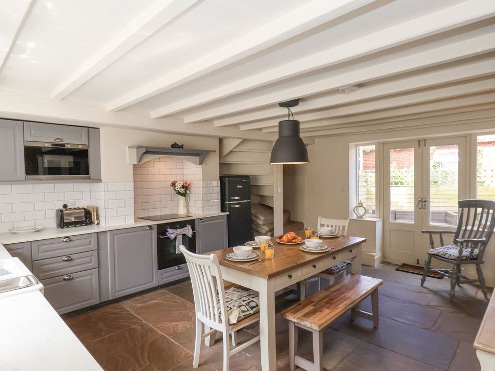 A kitchen with a dining table and chairs at Greenfingers in Whitby