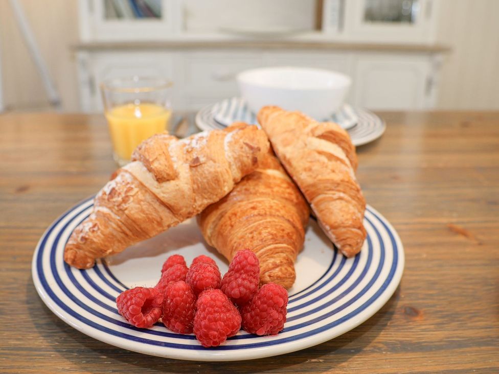 A breakfast setup with croissants and raspberries at Greenfingers in Whitby