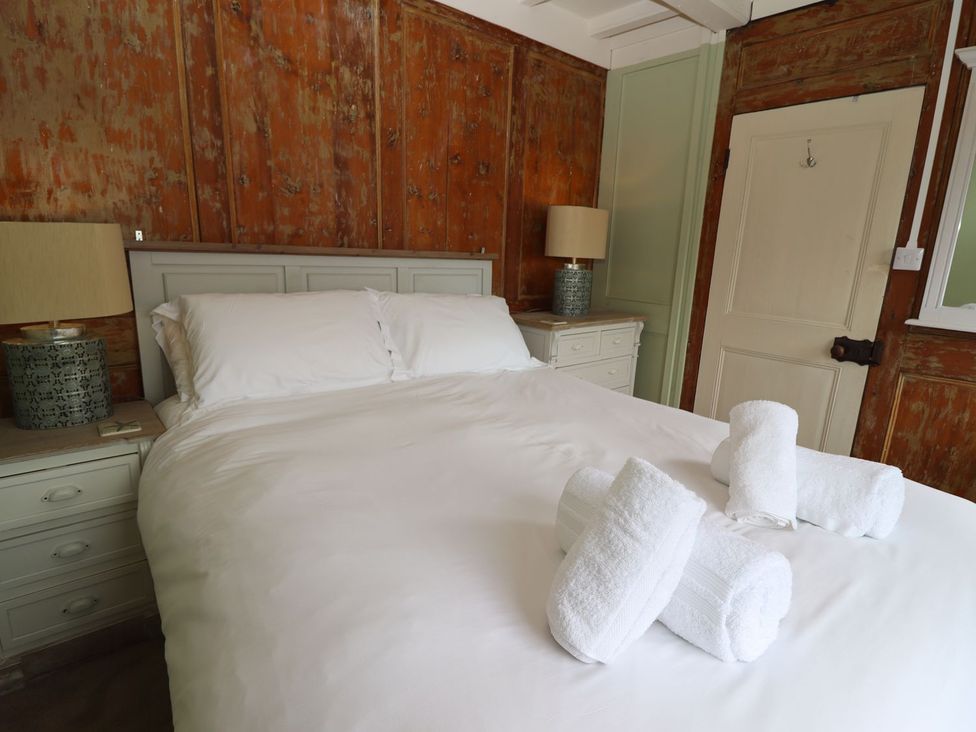 A bedroom with a bed and nightstand at Greenfingers in Whitby